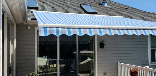 Blue-and-white striped Sunshield awning shading a residential deck